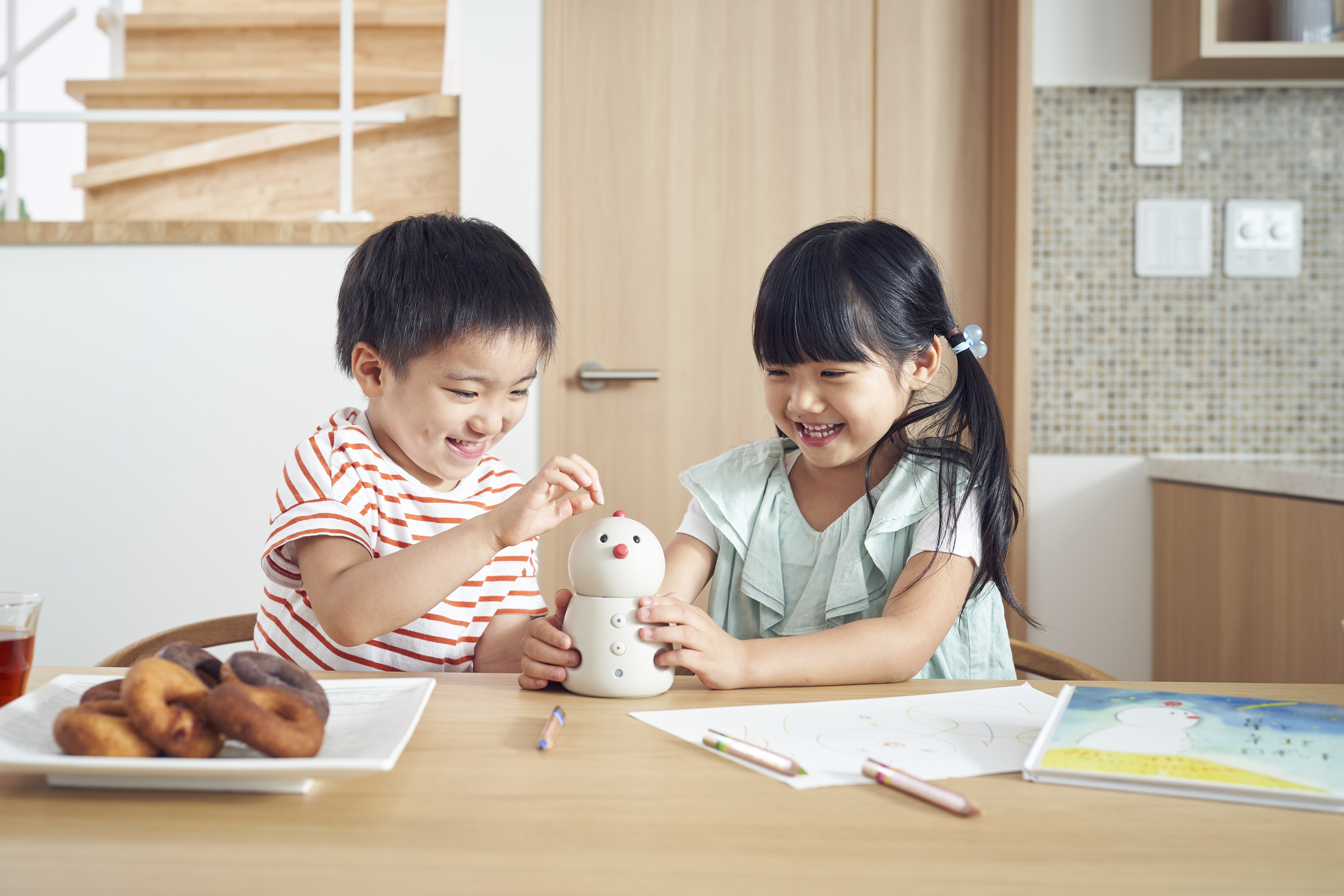 BOCCO emo communication robot by Yukai Engineering in a home setting, illustrating Japanese AgeTech for senior monitoring and family connectivity.
